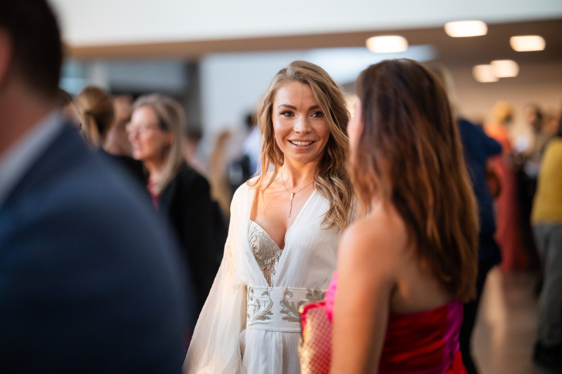 Two guests in conversation during a reception