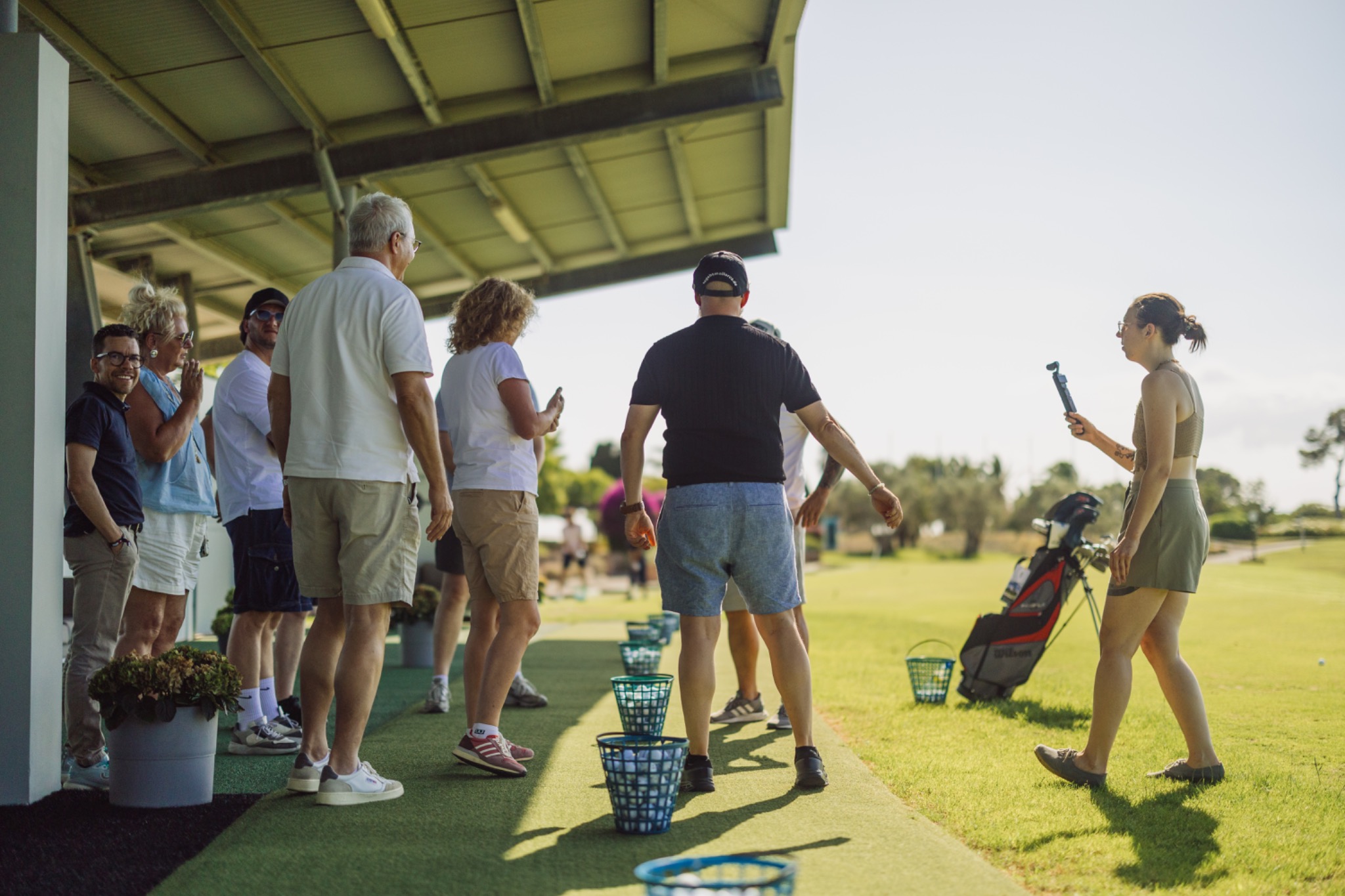 The group gathering at the golf practice area