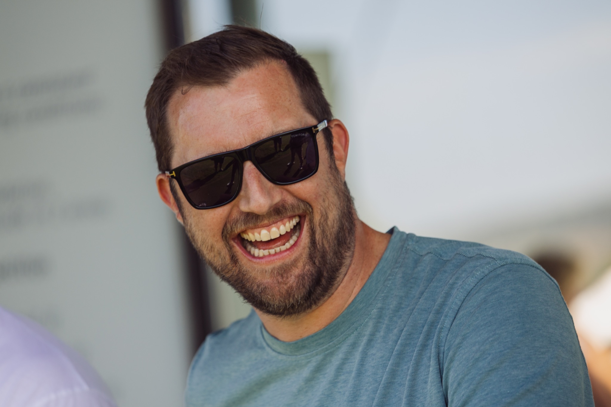 A guest laughing during a relaxed moment at the event