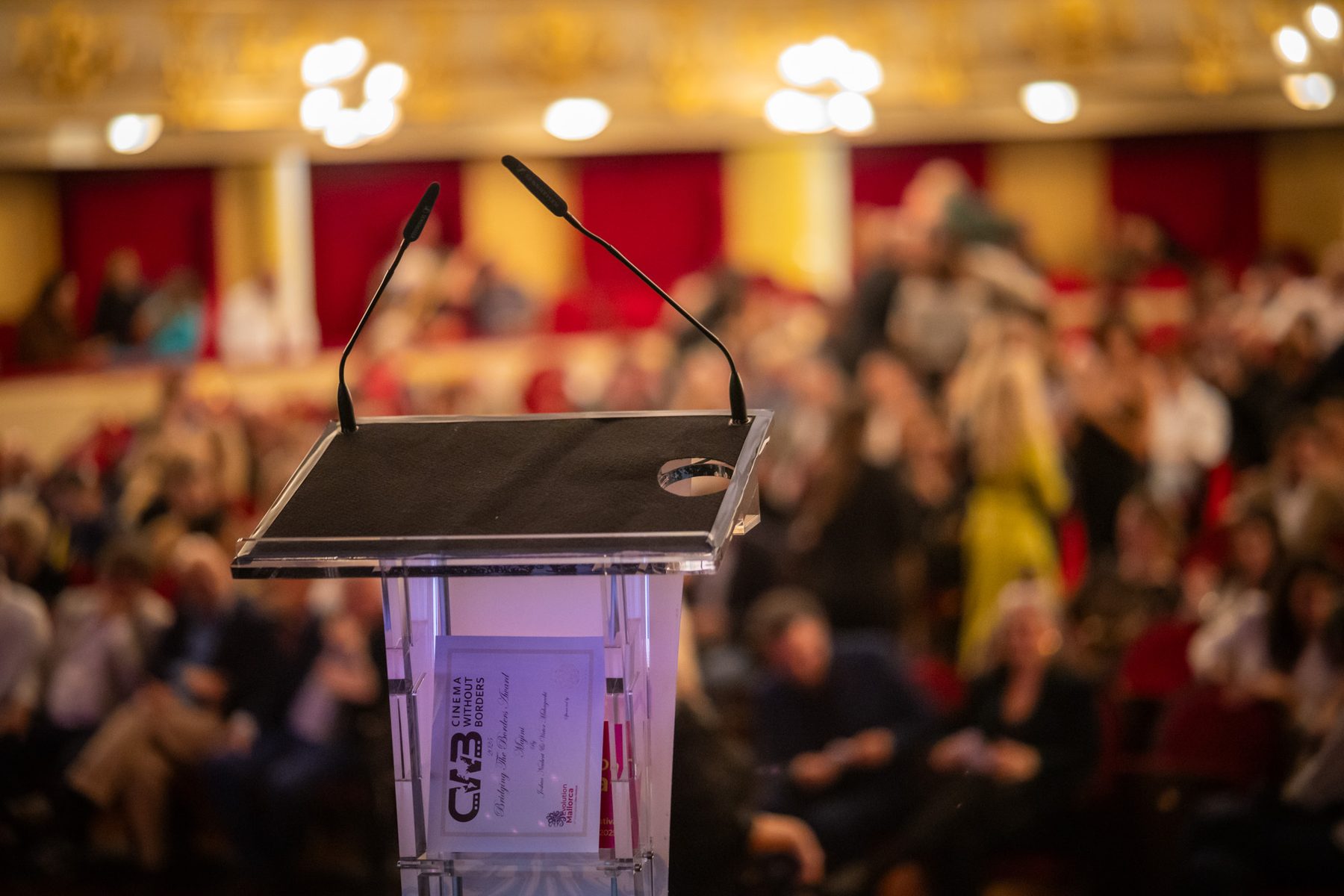 A lectern facing a seated audience in a conference setting