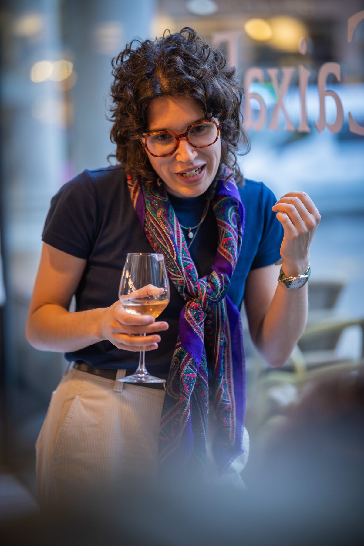 Guest laughing with a glass of wine during a reception