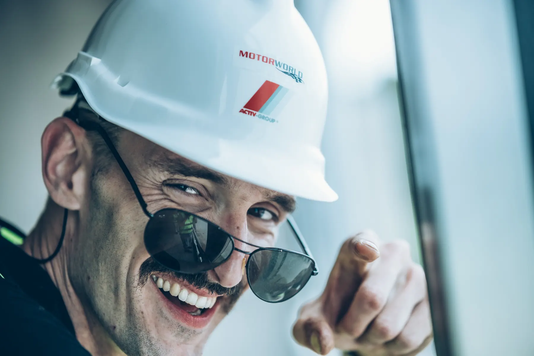 Man in a hard hat laughing outdoors