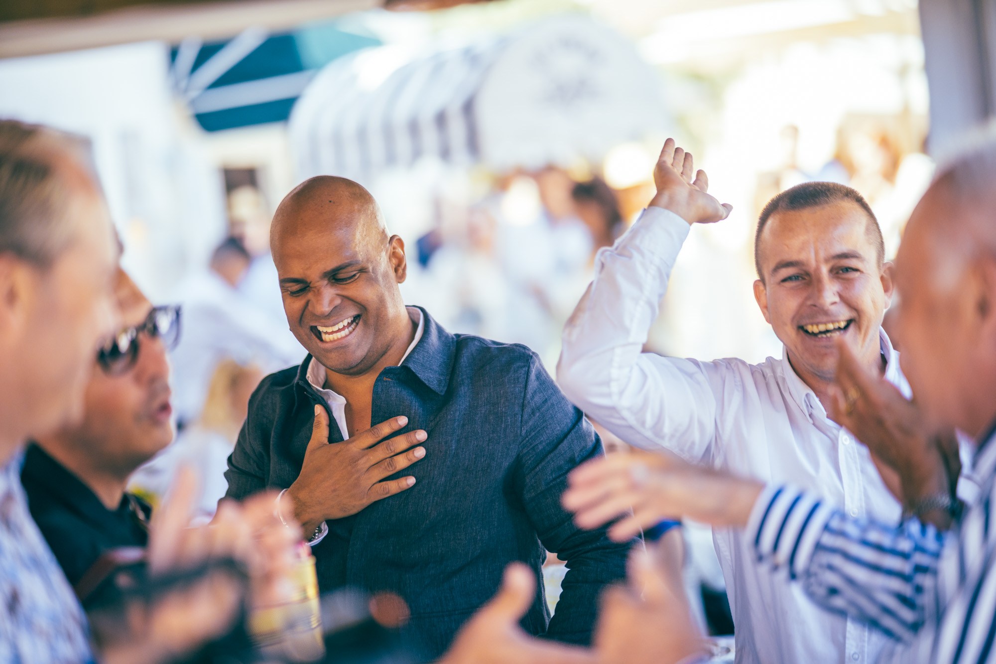 Two guests laughing and gesturing during an event.