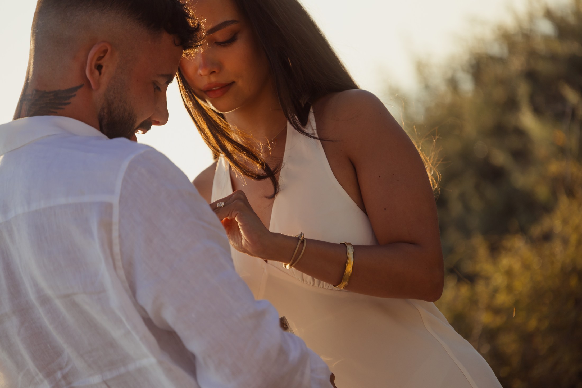 Couple sharing a quiet moment in warm evening light.