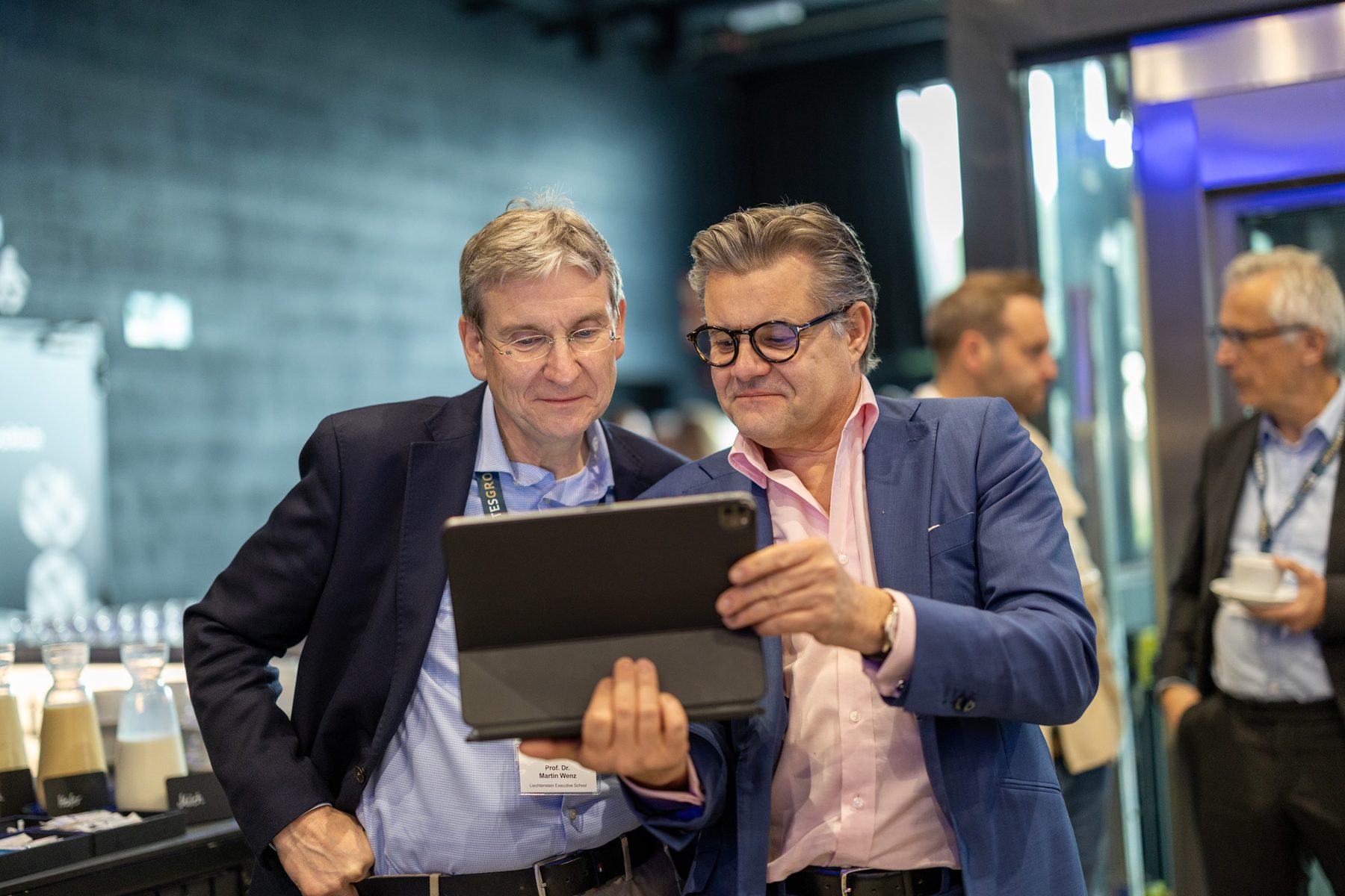 Two guests looking at a tablet during an event