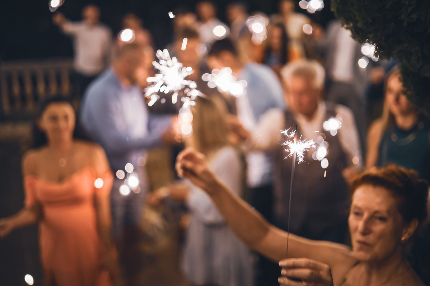 A guest holding a sparkler during the evening celebration.