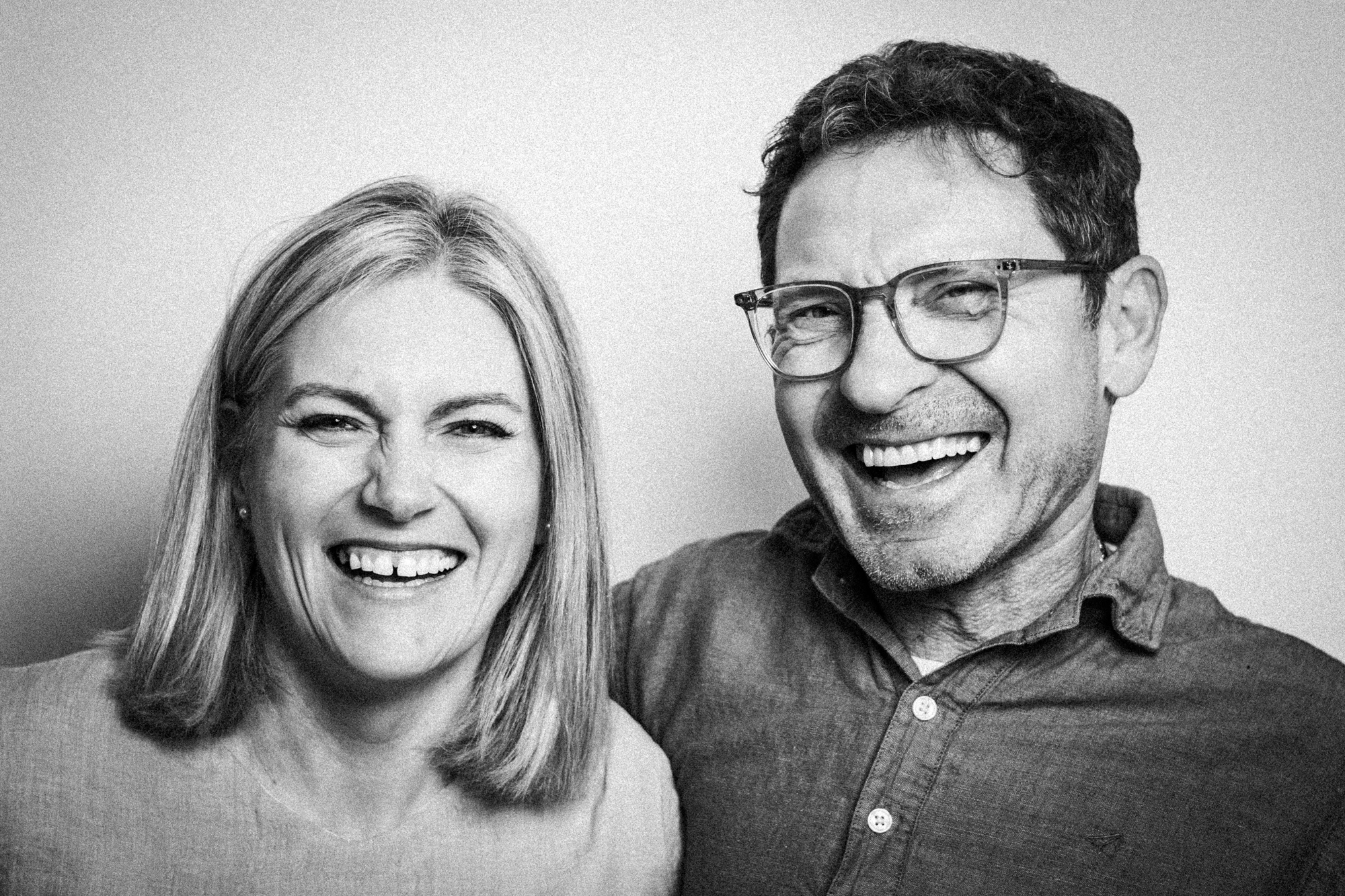 Black and white portrait of a smiling couple.